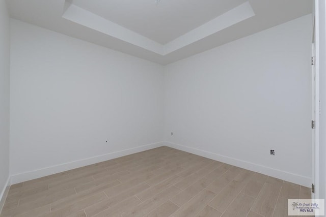 8830 Wentz Lk, Brownsville, TX 78520 - spare room featuring wood tiled floors, a raised ceiling, and baseboards