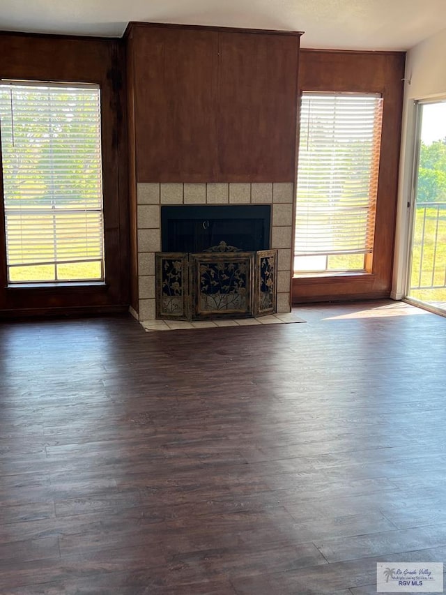 unfurnished living room featuring dark hardwood / wood-style flooring and a fireplace