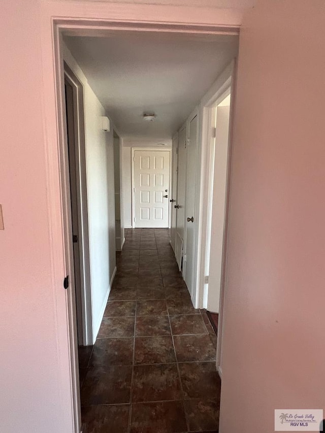 corridor with dark tile patterned floors