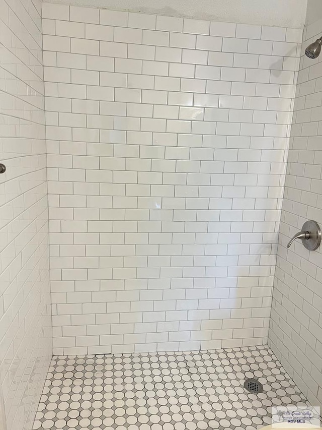 bathroom with tiled shower