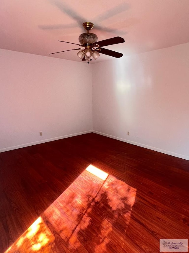 spare room featuring ceiling fan and dark hardwood / wood-style flooring