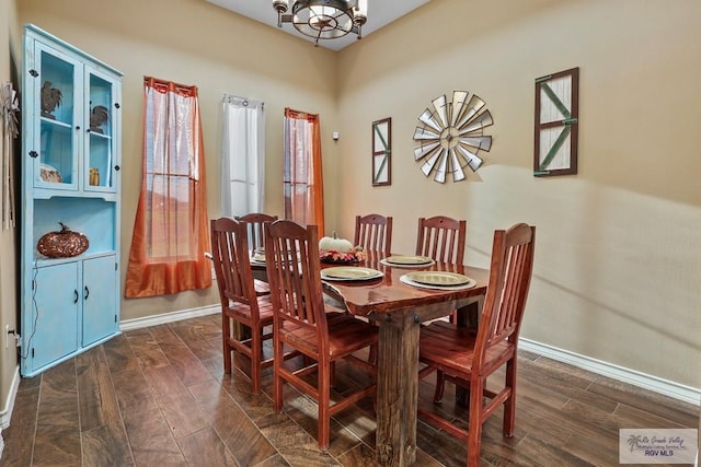 dining room featuring a chandelier and dark hardwood / wood-style floors