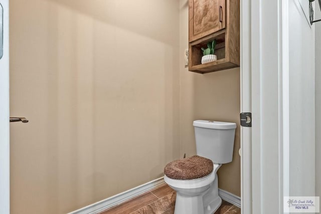 bathroom with wood-type flooring and toilet