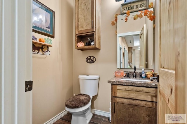 bathroom with tile patterned flooring, vanity, and toilet