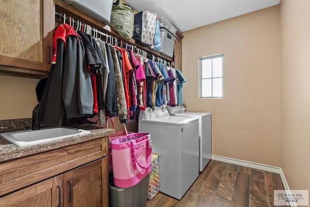 clothes washing area with cabinets, separate washer and dryer, dark hardwood / wood-style floors, and sink