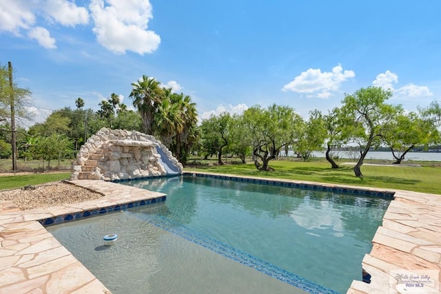 view of pool featuring a yard