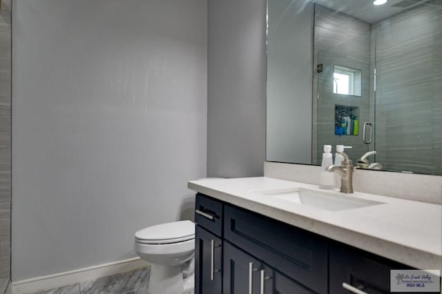 full bathroom with a stall shower, toilet, vanity, and baseboards