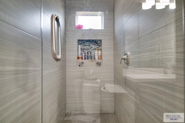 full bath featuring a tile shower