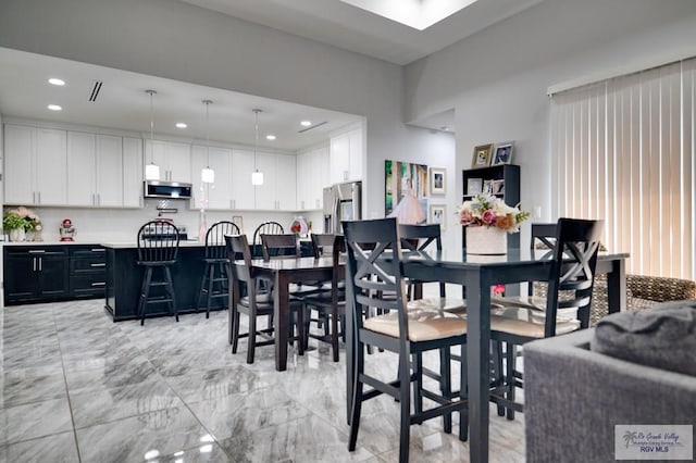 dining room with recessed lighting and marble finish floor