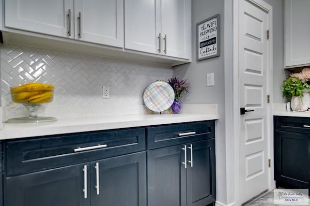 kitchen featuring light countertops and backsplash