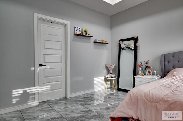 bedroom featuring baseboards and marble finish floor