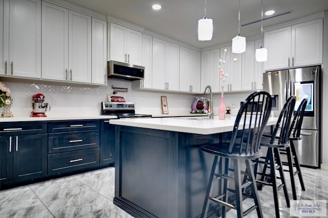 kitchen featuring pendant lighting, marble finish floor, a breakfast bar, stainless steel appliances, and light countertops