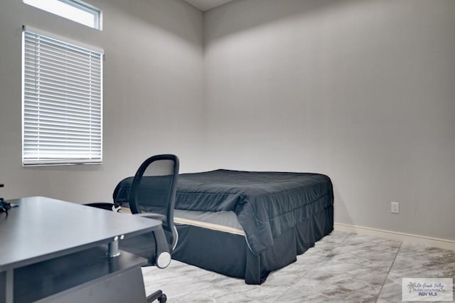 bedroom featuring baseboards