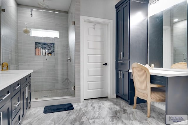 full bath featuring a shower stall, vanity, and marble finish floor