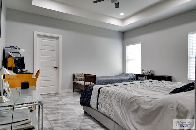 bedroom featuring a raised ceiling, recessed lighting, baseboards, and ceiling fan