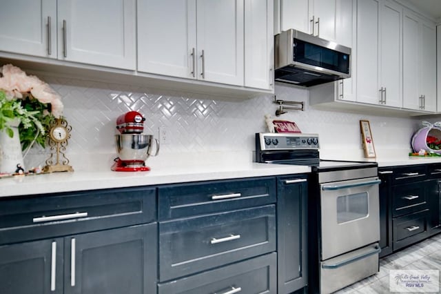 kitchen featuring backsplash, appliances with stainless steel finishes, and light countertops