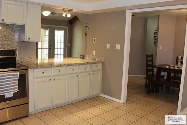 kitchen with white cabinetry, light tile patterned flooring, electric stove, and french doors