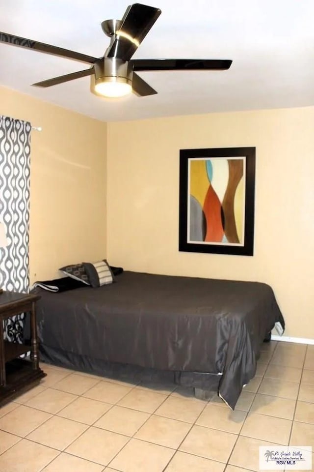 tiled bedroom with ceiling fan