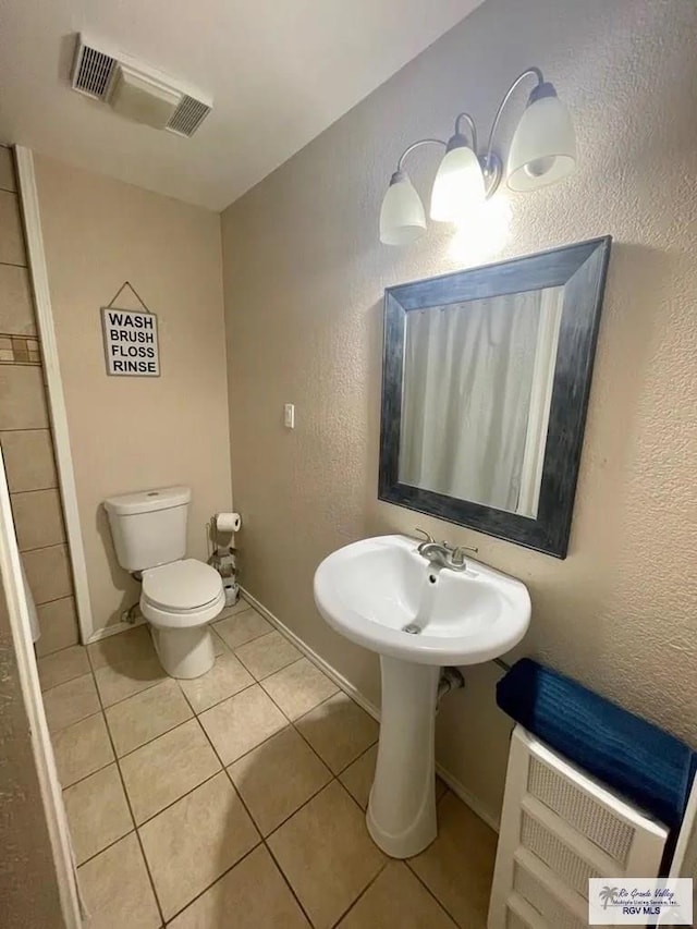 bathroom with tile patterned flooring and toilet