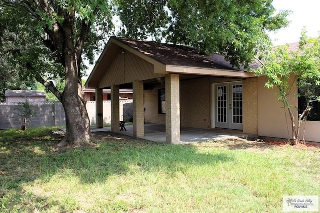 exterior space with a patio area and a lawn