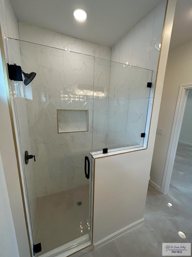 bathroom featuring a shower with shower door