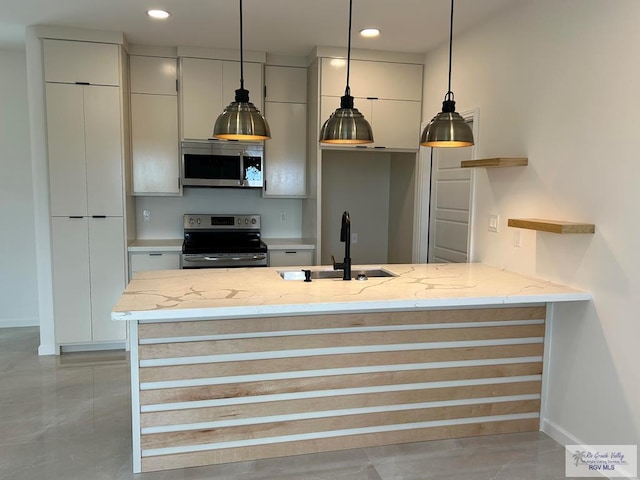 kitchen with hanging light fixtures, sink, light stone countertops, appliances with stainless steel finishes, and kitchen peninsula