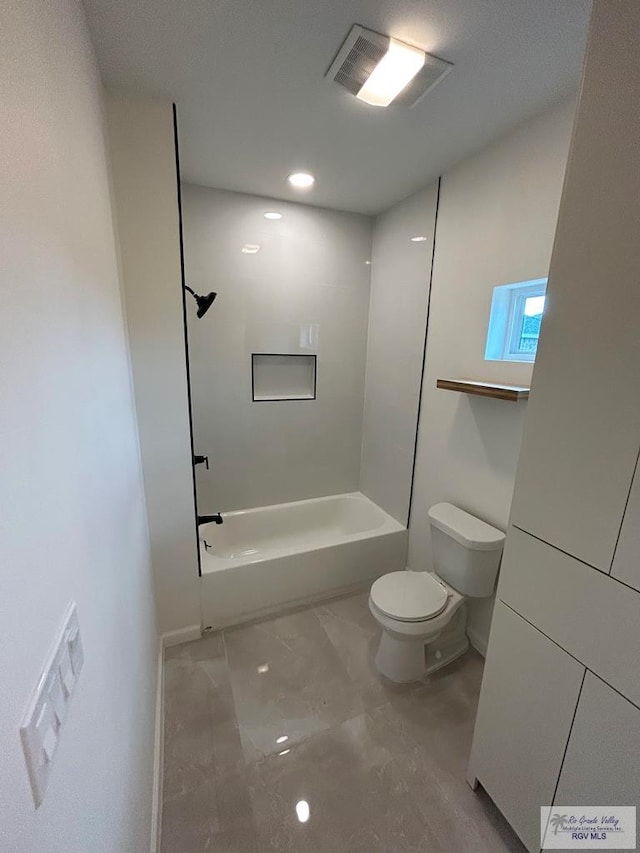 bathroom featuring shower / bathing tub combination and toilet