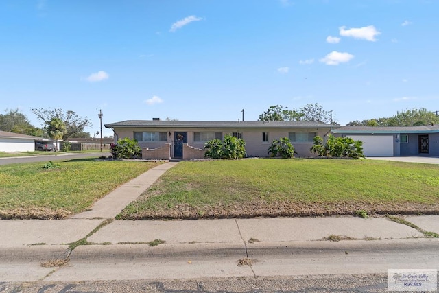 ranch-style house with a front yard and a garage