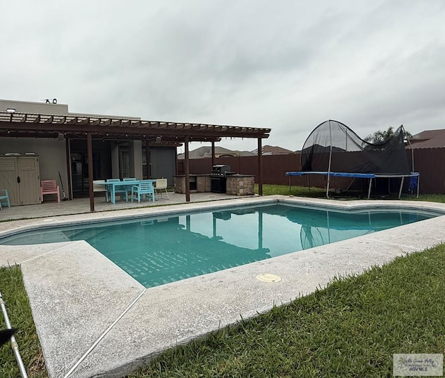 6200 Rio Sena St, Brownsville, TX 78526 - view of swimming pool featuring a trampoline, fence, a patio area, a pergola, and an outdoor kitchen