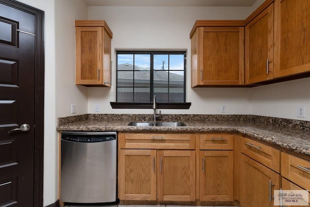 6705 Stone Oak Dr, Brownsville, TX 78526 - kitchen with stainless steel dishwasher, a sink, dark countertops, and brown cabinets