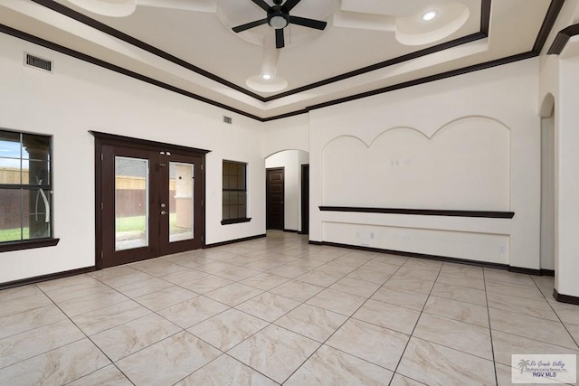 6705 Stone Oak Dr, Brownsville, TX 78526 - empty room with a tray ceiling, ornamental molding, ceiling fan, arched walkways, and baseboards