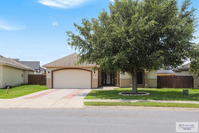 6705 Stone Oak Dr, Brownsville, TX 78526 - view of front of house with an attached garage, concrete driveway, and stucco siding