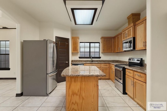 6705 Stone Oak Dr, Brownsville, TX 78526 - kitchen with stainless steel appliances, a kitchen island, a sink, and stone countertops