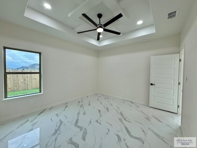 empty room with a tray ceiling, visible vents, baseboards, and recessed lighting