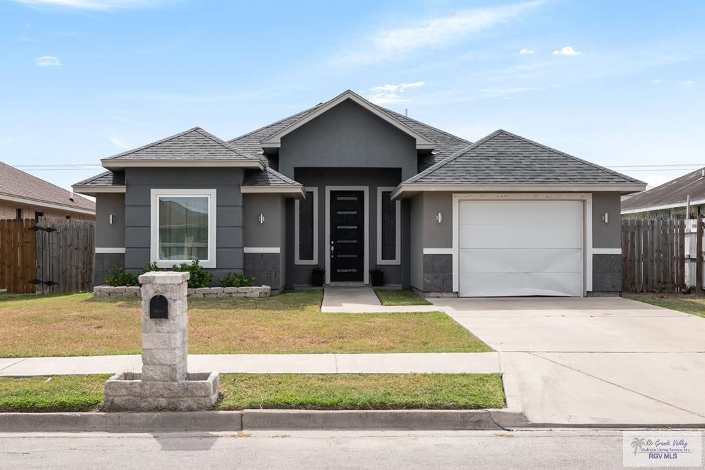 view of front of house featuring a front lawn and a garage