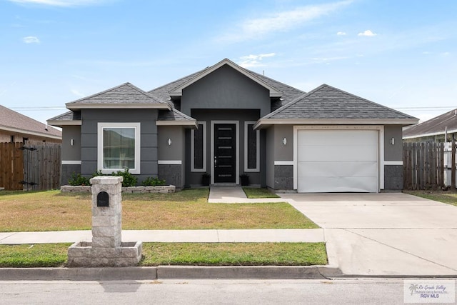 view of front of house featuring a front lawn and a garage