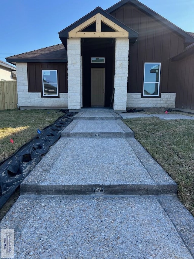 doorway to property featuring a yard