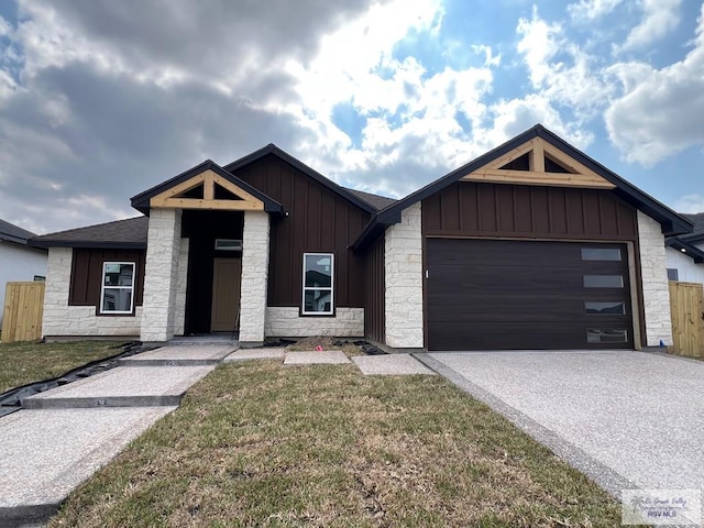 view of front of property featuring a garage and a front lawn