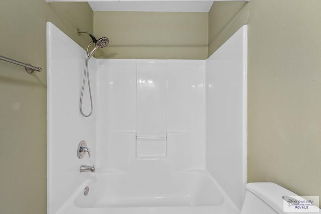 bathroom with toilet and shower / bathtub combination