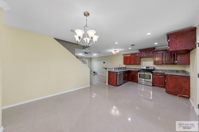 kitchen with light tile patterned floors, appliances with stainless steel finishes, decorative light fixtures, light stone counters, and a chandelier