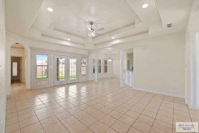 3271 Emerald Valley Blvd Unit 8, Brownsville, TX 78526 - spare room featuring ornate columns, a ceiling fan, light tile patterned flooring, a raised ceiling, and arched walkways