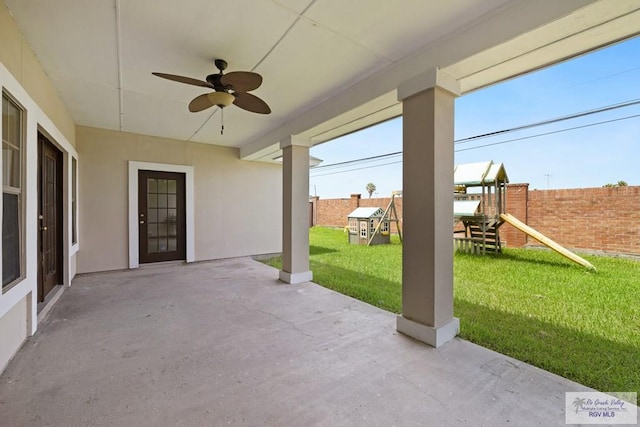 3271 Emerald Valley Blvd Unit 8, Brownsville, TX 78526 - fenced backyard featuring a playground, a ceiling fan, and a patio