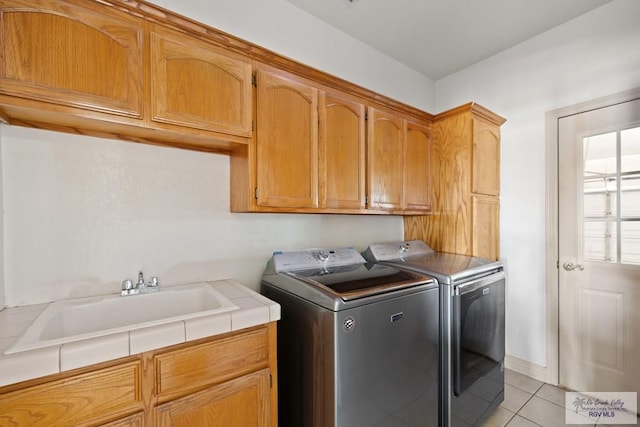3271 Emerald Valley Blvd Unit 8, Brownsville, TX 78526 - washroom featuring cabinet space, washer and dryer, and light tile patterned floors