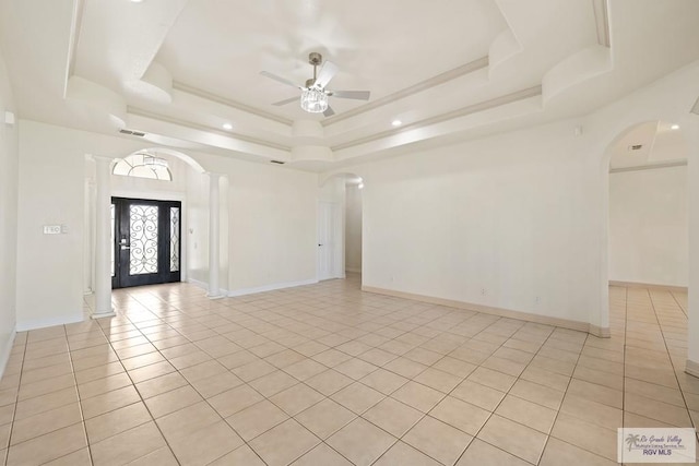3271 Emerald Valley Blvd Unit 8, Brownsville, TX 78526 - empty room featuring arched walkways, a raised ceiling, light tile patterned floors, and ceiling fan