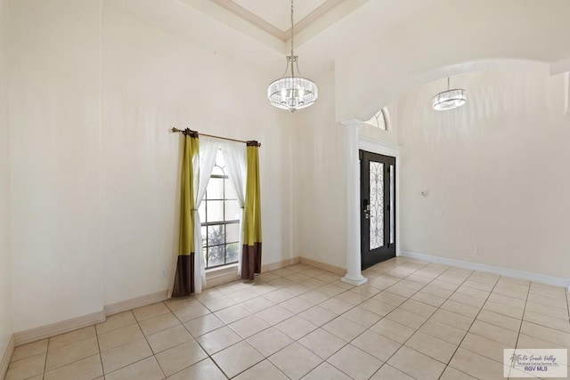 3271 Emerald Valley Blvd Unit 8, Brownsville, TX 78526 - spare room featuring light tile patterned flooring, arched walkways, a towering ceiling, and a chandelier