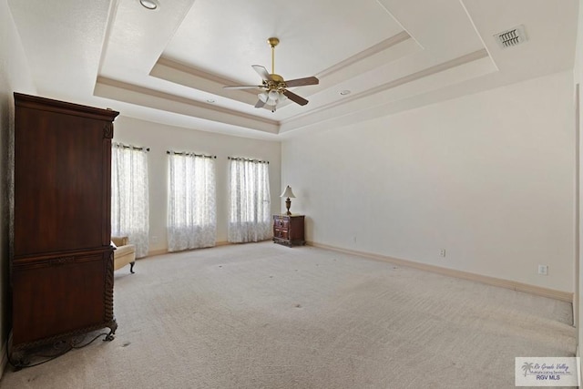 3271 Emerald Valley Blvd Unit 8, Brownsville, TX 78526 - empty room featuring a raised ceiling, light colored carpet, and a ceiling fan