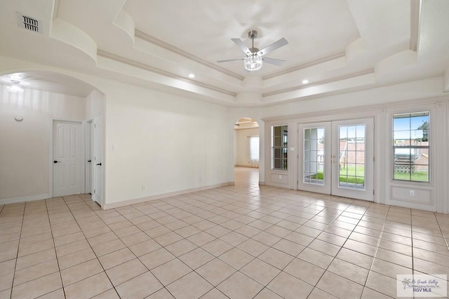 3271 Emerald Valley Blvd Unit 8, Brownsville, TX 78526 - empty room featuring arched walkways, ceiling fan, a raised ceiling, light tile patterned flooring, and french doors