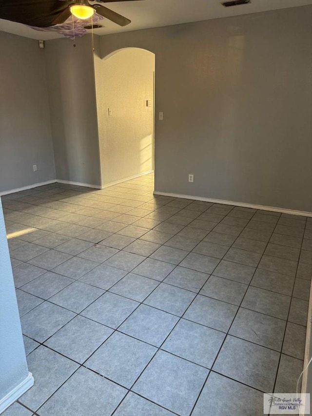 empty room with light tile patterned floors and ceiling fan