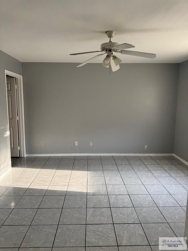 tiled empty room with ceiling fan