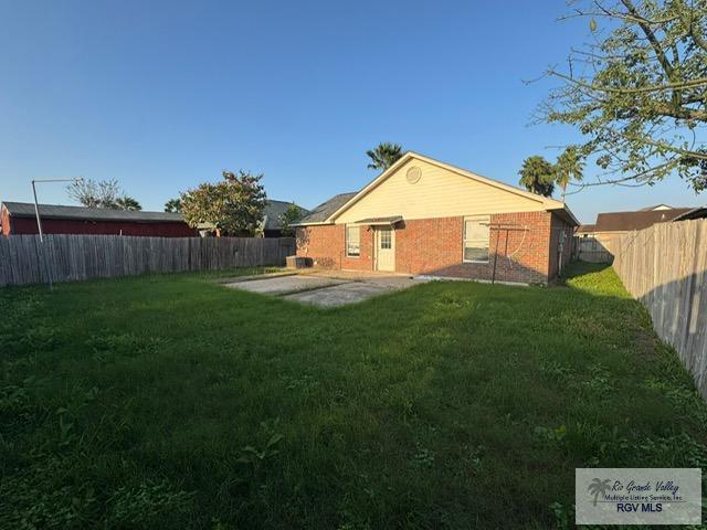 back of property with a patio and a lawn